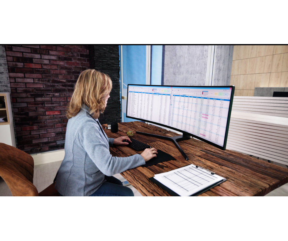 Woman using computer to work on spreadsheets.